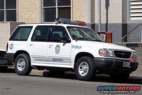 White police SUV with light bar, 'Police' text, and unit number 008008 visible