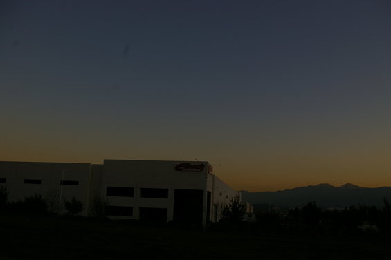 Building with a red logo against a twilight sky