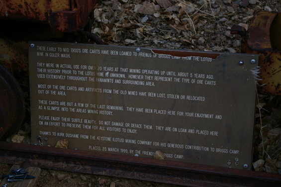 Sign about early to mid 1900s ore carts loaned to Friends of Briggs Camp from the Lotus Mine