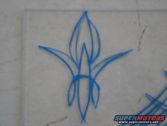 blue pinstripe art on a light gray surface, with a watermark at the bottom right