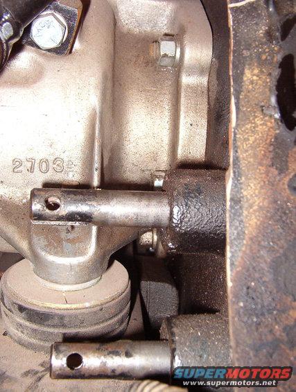03nuts.jpg With the rubber bumper installed at the back of the crossmember, it's impossible to get to the lower L nut.  And it takes a 4-way wrench to get to the middle L (almost visible above the upper shift rail).

The adapter required clearancing of the crossmember in several spots, and 1/2&quot; of washers on each trans mount.  See the NEXT pic...