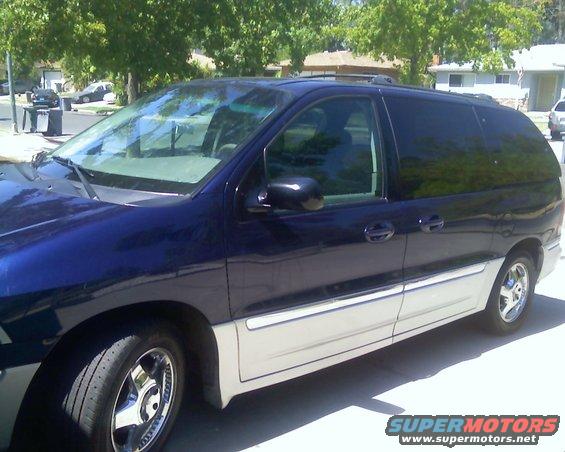 Blue and silver 2000 Ford Windstar minivan, 3/4 front view