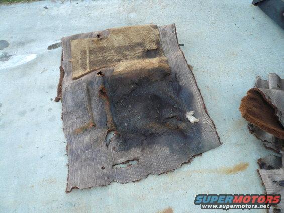 worn out car floor mats on concrete