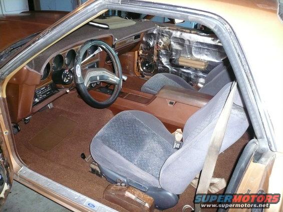 1975 Ford Ranchero interior showing brown carpet, grey seats, and dashboard