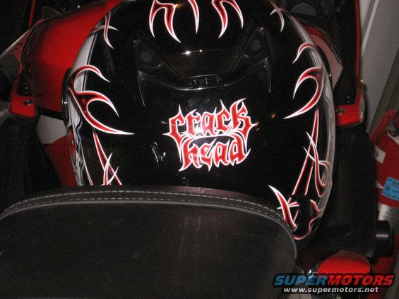 Black motorcycle helmet with red and white flames and 'crack head' text