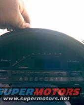 Dashboard gauge cluster with "SUPERMOTORS www.supermotors.net" text overlay