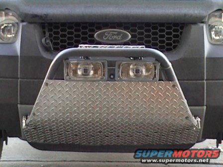 Front of a 2006 Ford Escape with a diamond plate bumper and auxiliary lights