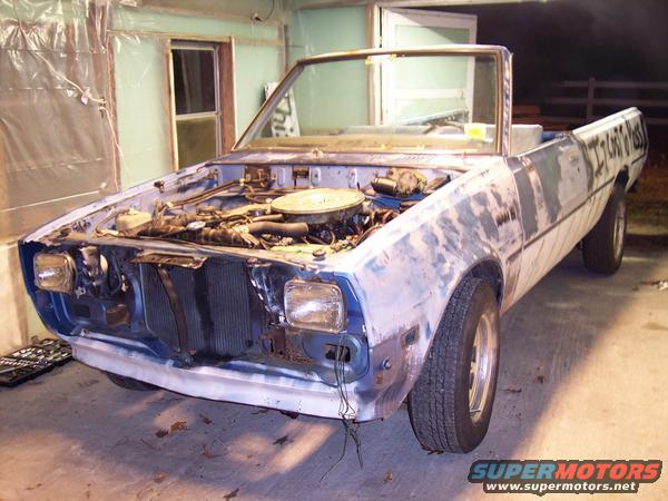 Convertible pickup truck with hood open, primer finish, text on bed