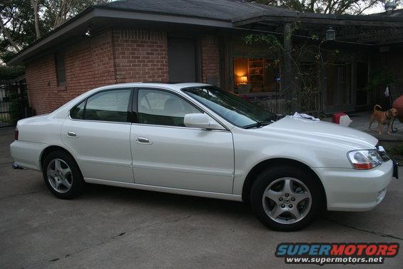 2003 Acura TL parked in front of a brick house, side view