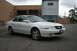 2003 Acura TL - A white 2003 Acura TL sedan is parked in front of a loading dock and a semi-trailer.