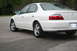 2003 Acura TL - A white 2003 Acura TL sedan is viewed from the rear quarter angle on a paved surface.