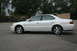 2003 Acura TL - Side profile of a white 2003 Acura TL sedan parked on asphalt.