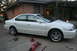 2003 Acura TL - White 2003 Acura TL on jack stands with a floor jack and scissor jack visible.