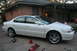 2003 Acura TL - A white 2003 Acura TL sedan is parked on a concrete driveway with car maintenance equipment nearby.