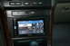 2003 Acura TL - The dashboard of a car features a Pioneer infotainment system tuned to 'the 90s' radio channel, showing song titles and artist information.