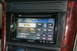 2003 Acura TL - Close-up of a car's center console showing a Pioneer aftermarket stereo system with a '90s' music channel displayed.