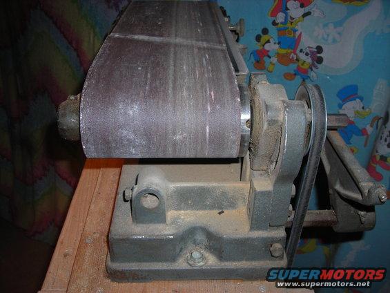 belt sander with worn sanding belt and motor pulley