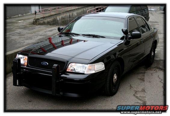 Black police car with push bumper, parked outside