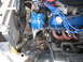 1985 Ford Crown Victoria LTD - Close-up of an engine bay, a blue alternator and various engine components.