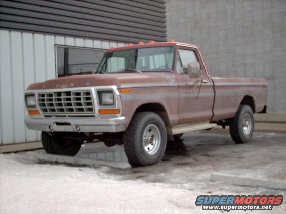 Red 1979 Ford F-250 pickup truck with chrome grille and bumper, parked outside