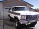 1978 Ford Bronco - This 1978 Ford Bronco is parked in a driveway in front of a house with a garage door.