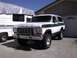 1978 Ford Bronco - This 1978 Ford Bronco is seen from the front, parked next to a covered RV.
