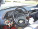 1981 Ford Bronco - The dashboard of a Ford truck is visible, with exposed wiring and an open glove compartment.
