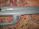 2004 Ford Crown Victoria - A section of car interior trim, possibly from a dashboard or door panel, is shown against a patterned carpet.