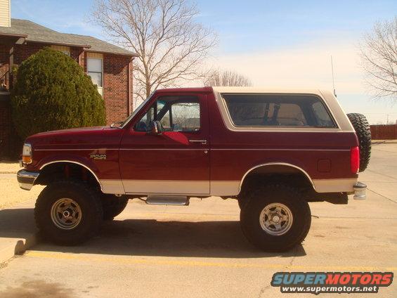 Maroon and tan 1992 Ford Bronco parked on asphalt