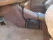 1992 Ford Bronco - The interior of a vehicle shows the floor, pedals, and a manual gear shifter.