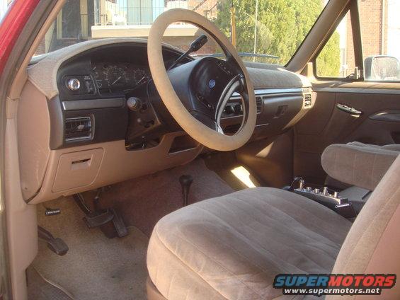1992 Ford Bronco interior with tan seats, dashboard, and steering wheel cover