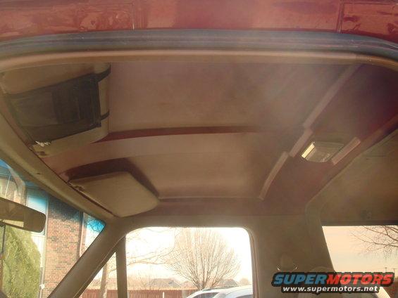 Interior ceiling view with sun visor and overhead light