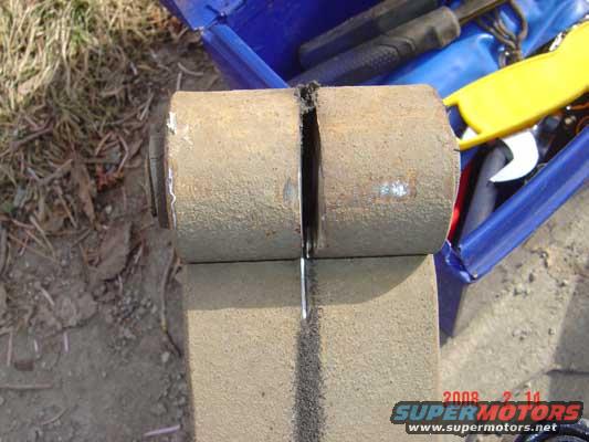 It was suggested to cut the bolt off on either side of the spring, between the spring and shackle.  I couldn't get that to work.  Kept dulling blades on the hardened bolt.  so I decided to cut the center of the bolt out with a cutting wheel on my angle grinder.  Worked like a charm.