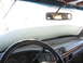 1995 Ford C-350 (Centurion Conversions) - Interior view of a vehicle's dashboard and steering wheel, with frost covering the windshield.
