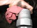 1995 Ford C-350 (Centurion Conversions) - Mechanic's hand with a rag and a socket wrench, likely for a front axle rebuild.