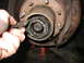 1995 Ford C-350 (Centurion Conversions) - Front wheel hub assembly being serviced, likely a manual locking hub.
