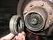 1995 Ford C-350 (Centurion Conversions) - The inner workings of a vehicle's front wheel hub assembly are exposed during maintenance.