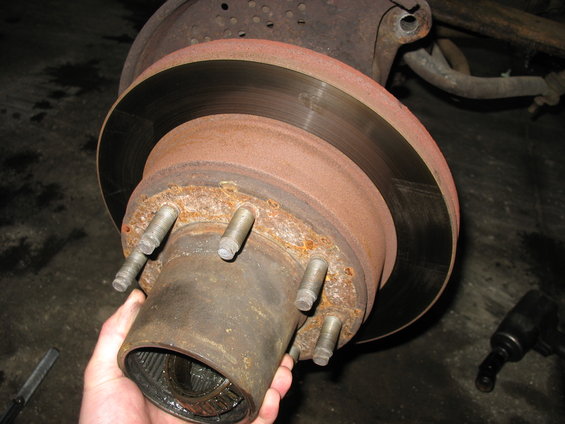 Front axle hub and rotor assembly with a hand holding the hub