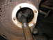 1995 Ford C-350 (Centurion Conversions) - Close-up of a splined axle shaft inserted into a rusty hub assembly, likely part of a front axle rebuild.