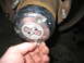 1995 Ford C-350 (Centurion Conversions) - Hand is shown adjusting a chrome 4x4 automatic hubcap on a vehicle's wheel hub.
