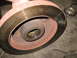 1995 Ford C-350 (Centurion Conversions) - A close-up view of a vehicle's brake rotor and hub assembly, showing the greased bearing.