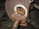 1995 Ford C-350 (Centurion Conversions) - Close-up view of a corroded vehicle axle part, indicating a need for repair or completion of a front axle rebuild.
