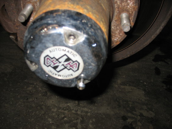 Close-up of an automatic locking hub with a circular sticker that says AUTOMATIC
