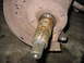 1995 Ford C-350 (Centurion Conversions) - Close-up of a rusted axle shaft and brake rotor, likely from a vehicle undergoing front axle work.
