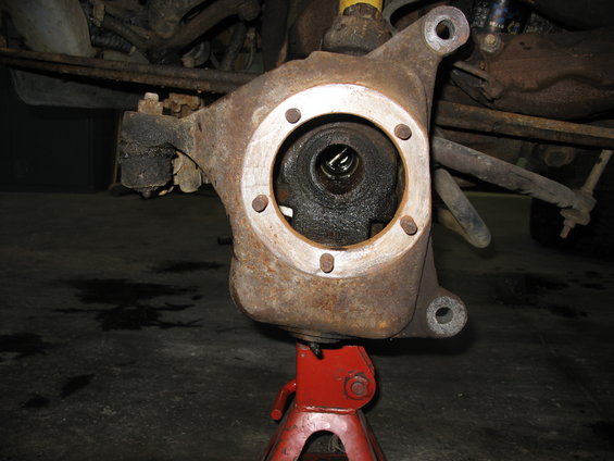 Front wheel hub assembly on a red jack stand, showing the center spindle area