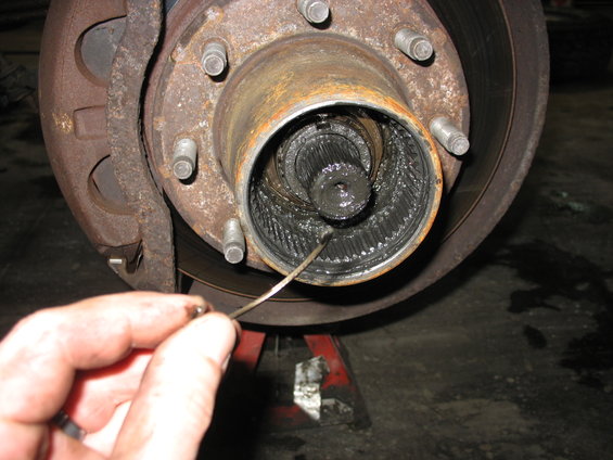 Front axle hub and splines with grease, being inspected