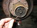 1995 Ford C-350 (Centurion Conversions) - Close-up view of a front axle hub and its splines, showing grease and signs of wear.