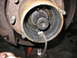 1995 Ford C-350 (Centurion Conversions) - Close-up view of a front axle hub, revealing a splined shaft covered in grease, indicative of a front axle rebuild.