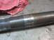 1995 Ford C-350 (Centurion Conversions) - A metal shaft with splines and visible wear marks is shown, possibly from a vehicle's axle.