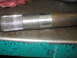 1995 Ford C-350 (Centurion Conversions) - A close-up view of a metal axle shaft, showing its splined end and a smooth, machined section.